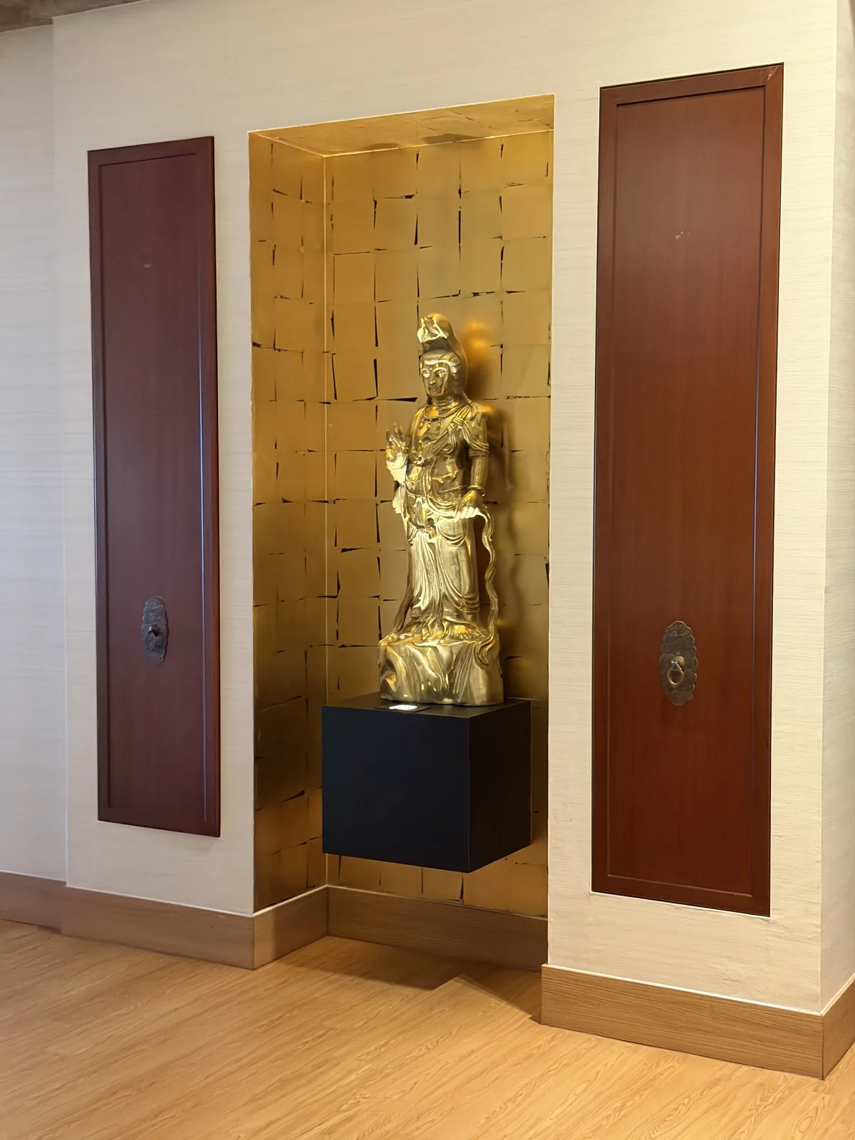 Gold-leaf display niche with concealed timber panel doors by Takumi