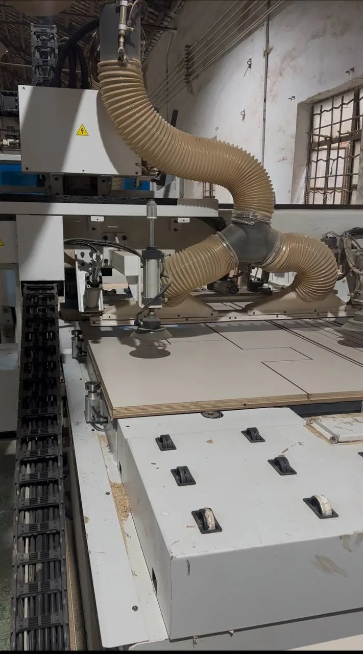 Precision machinery cutting plywood at the Takumi workshop