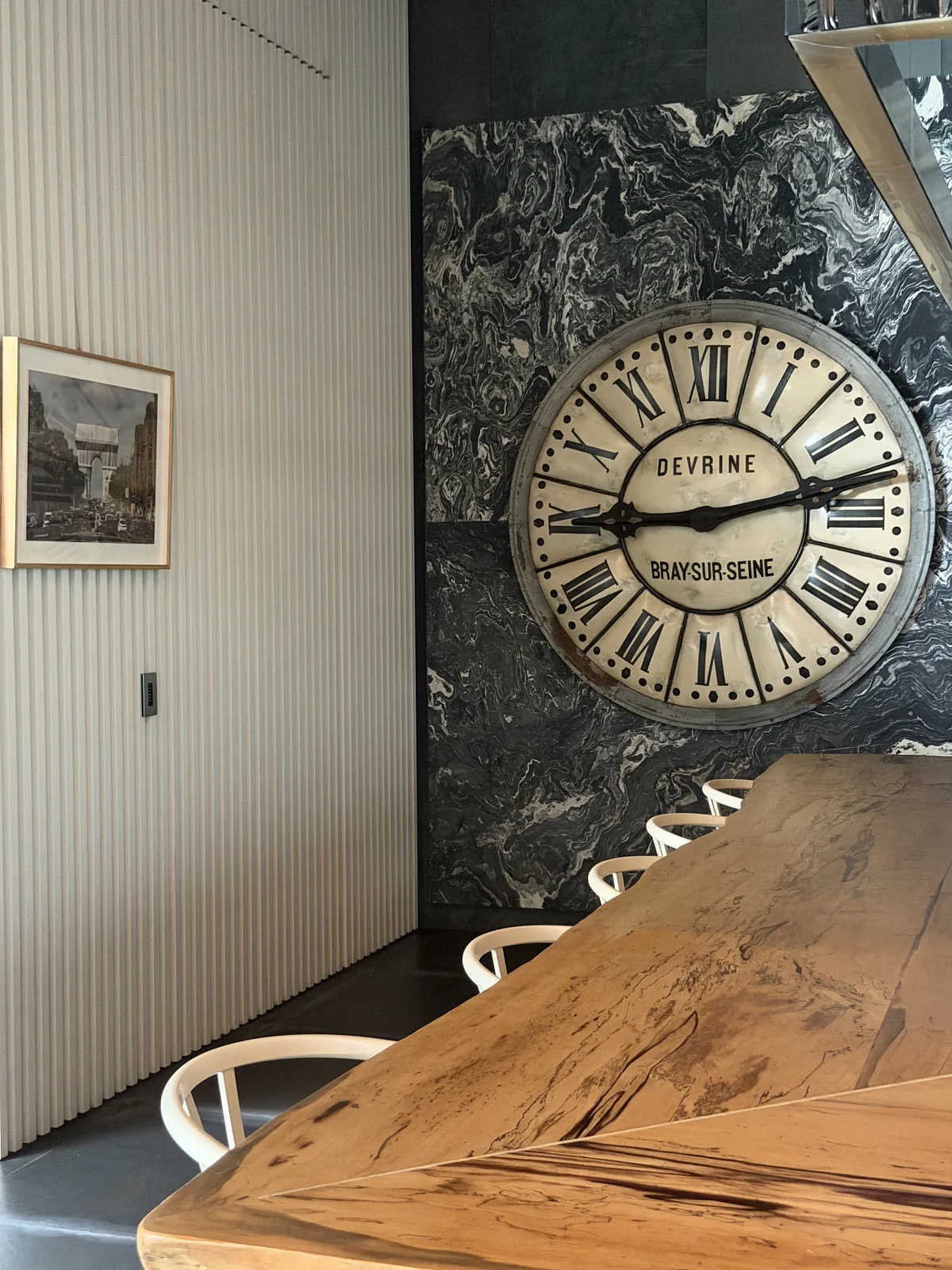 Dining area with marble feature wall and solid timber table, Singapore