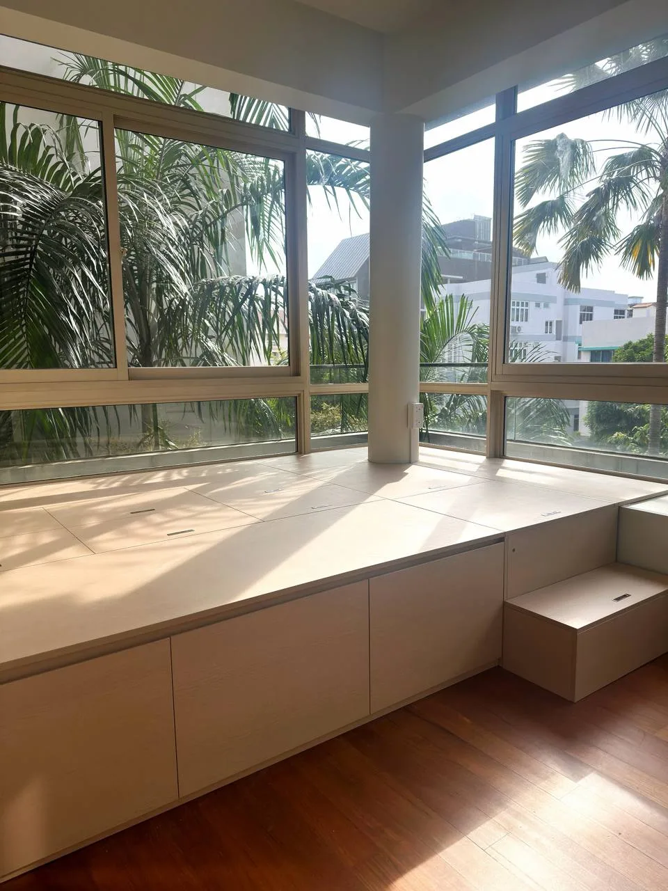 Custom platform bed with storage built by a window