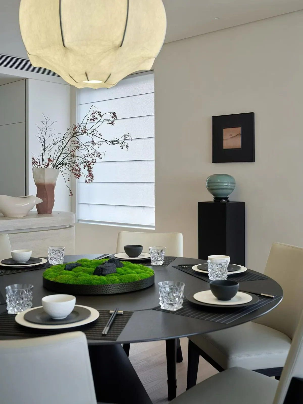 Round timber dining table setting in a Singapore home