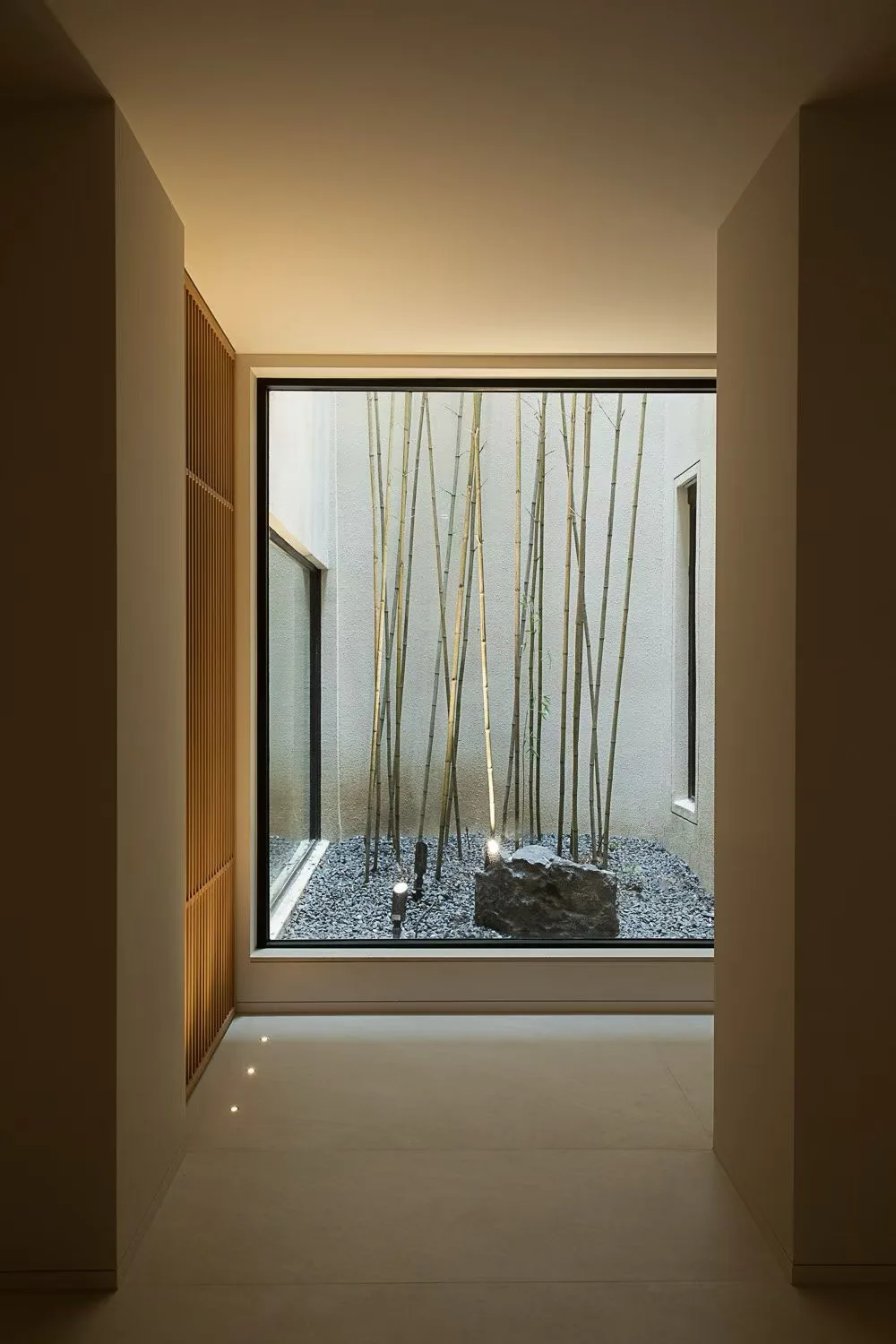 Timber slat wall corridor overlooking a bamboo courtyard, Singapore